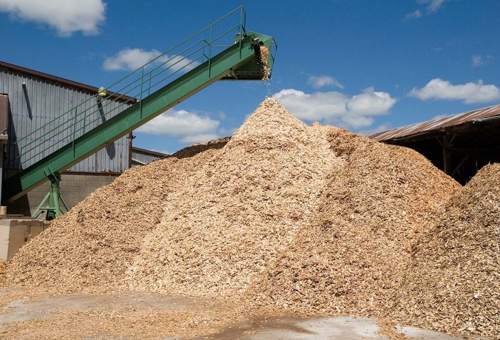 Pelletized carbon feedstock is staged in a production facility. Pelletized biochar can be used where consistent particle form is required for manufacturing.